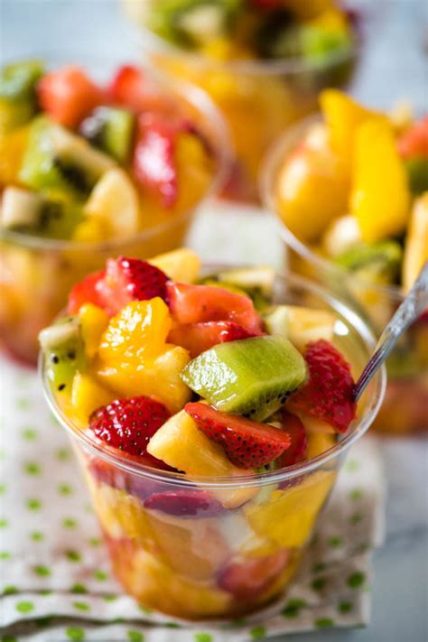 A tropical fruit cup with pineapple, mango, and kiwi