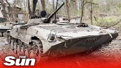 Ukrainian forces inspect destroyed Russian tank