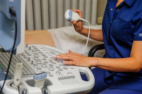 Ultrasound technologist preparing a patient for a cardiovascular sonography procedure