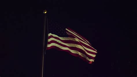 The American flag waving at night