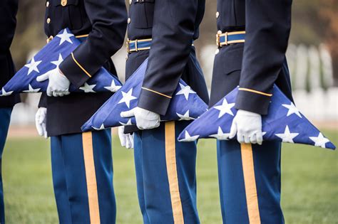 US soldiers folding the American flag