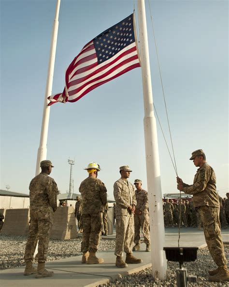 US soldiers lowering the American flag