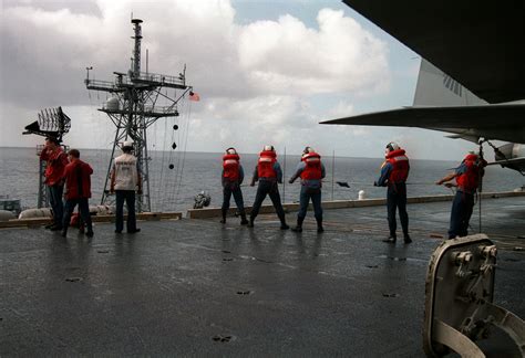 Crew members on the USS Abraham Lincoln, at work and play