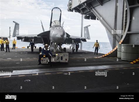 The USS Abraham Lincoln's hangar bay, with aircraft undergoing maintenance