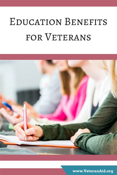 A photo of a veteran in a classroom, smiling and looking at a laptop