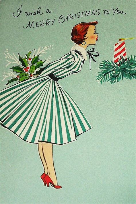 A person holding a vintage Christmas postcard, surrounded by modern technology