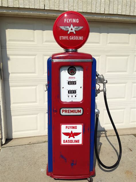 A vintage gas pump with a unique shape and design