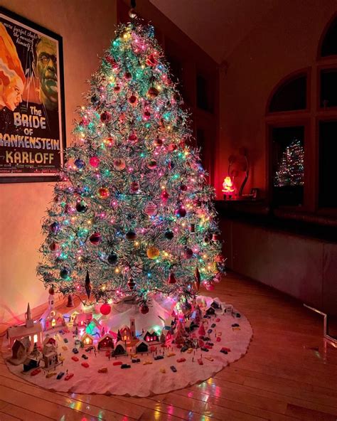 A vintage-themed tree with mercury glass, pearls, and gold ornaments