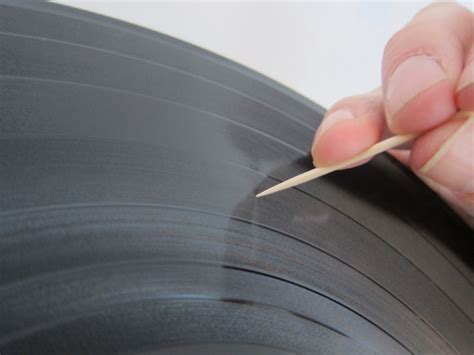 A close-up of a vinyl record with a scratch