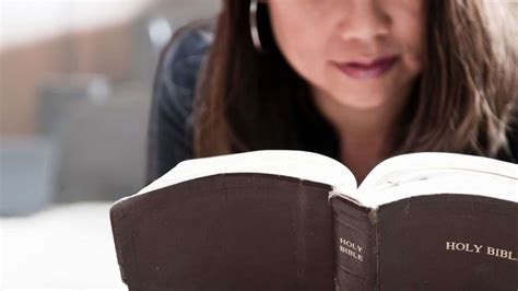 Woman reading Bible and journaling