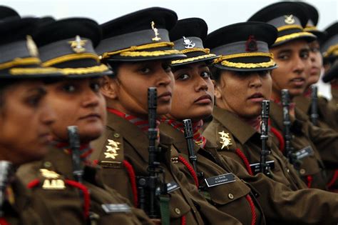 A photo of a female soldier with a sign that reads 'Empowerment'