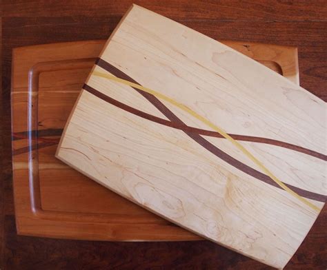 A wood inlay and carved handle for a cutting board