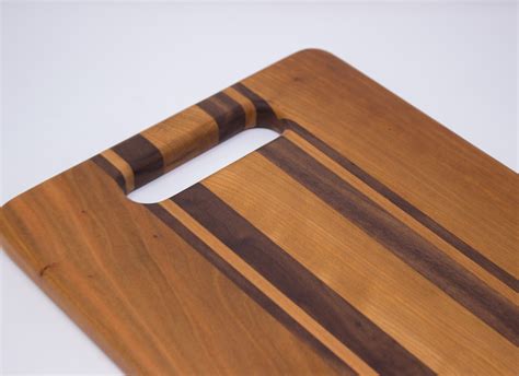 A wood inlay handle for a cutting board