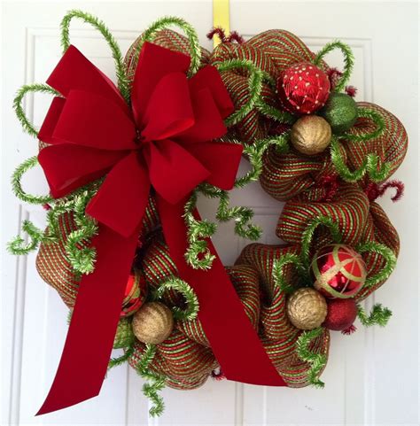 A selection of wreath decorations featuring gold bows and lush greenery