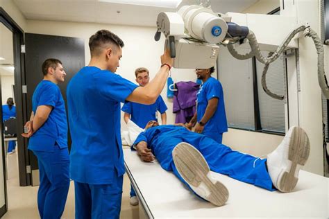 X-ray technician preparing a patient for an X-ray