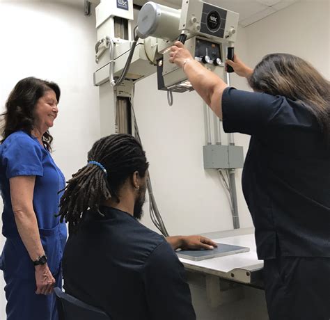 X-ray technician preparing patient for procedure